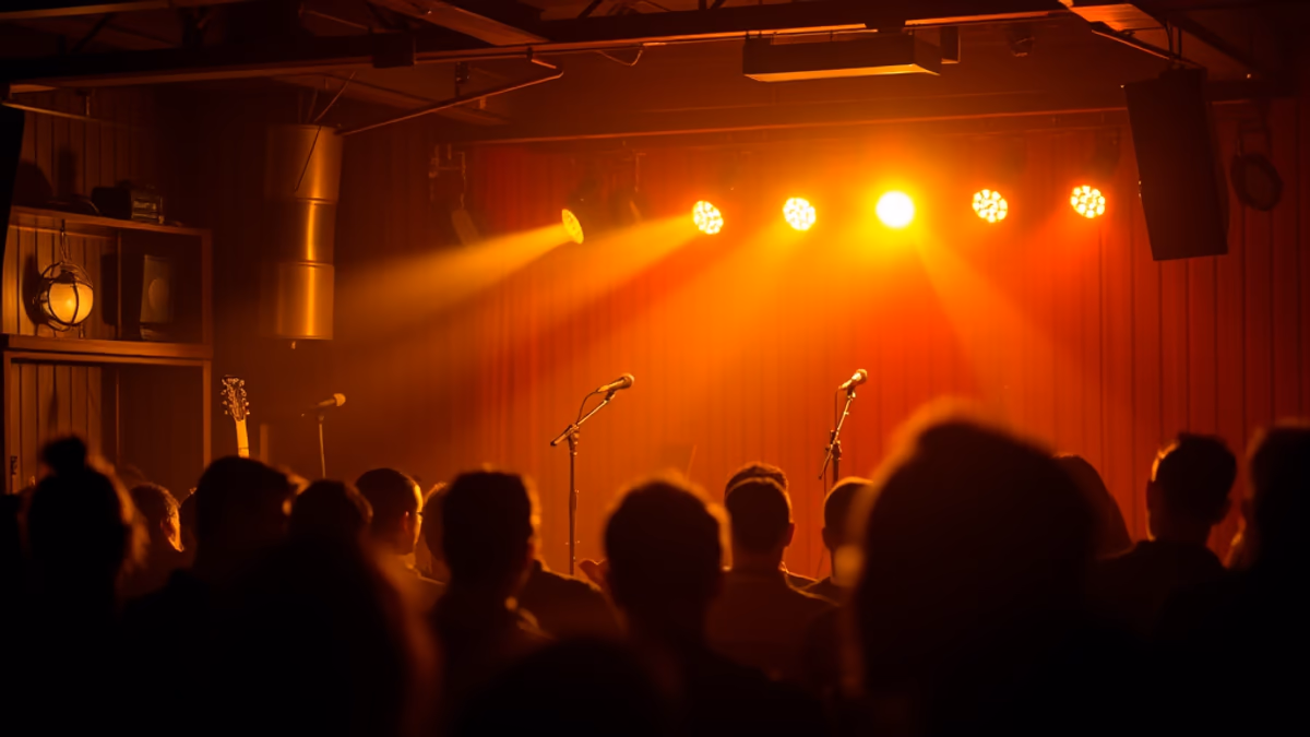 YMCA Boulton Center stage with an acoustic performer and a small audience at table seating